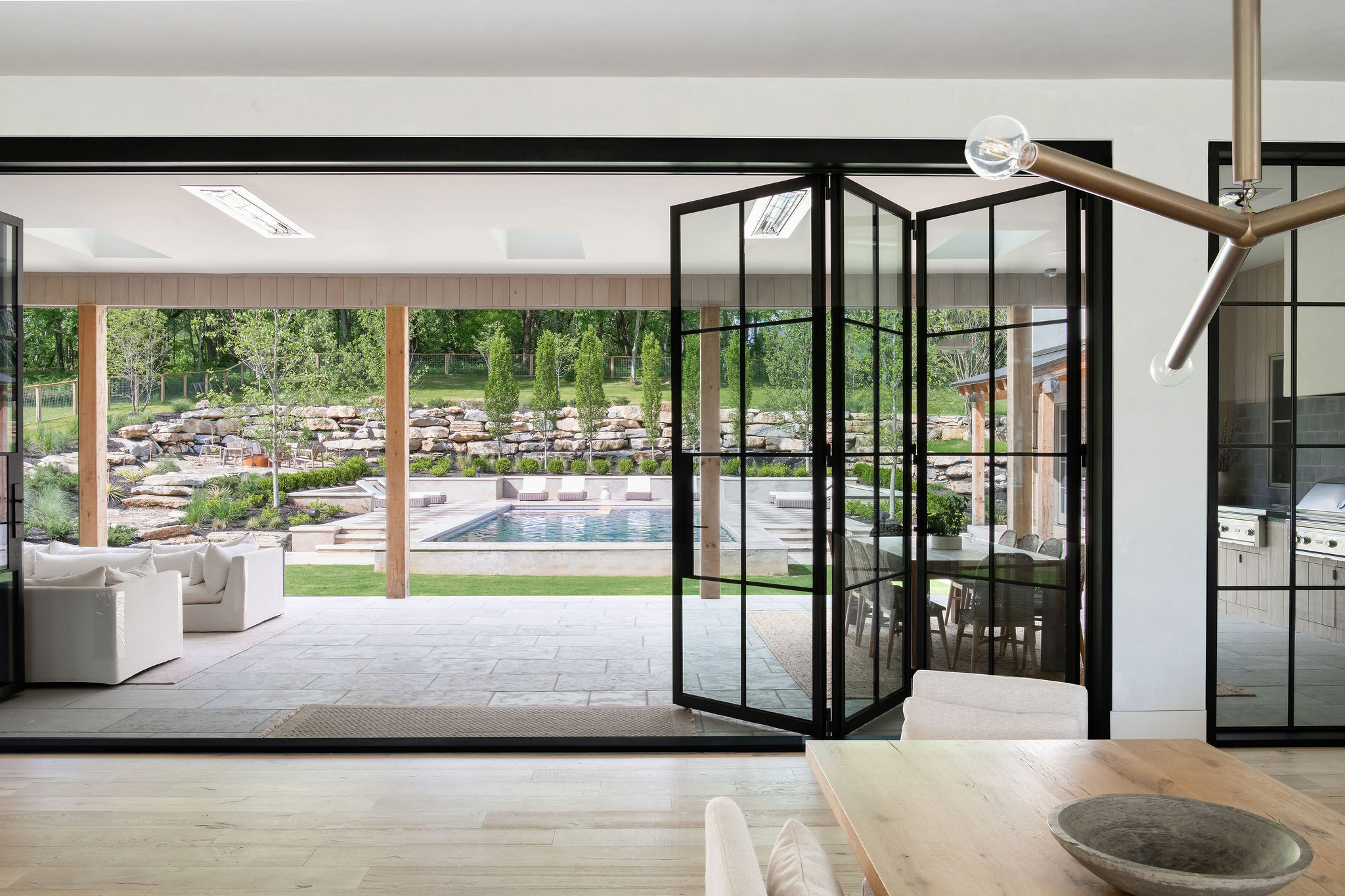 Seamless Transitions: Design Tips for Incorporating Pivot and Accordion Doors into Modern Indoor-Outdoor Spaces